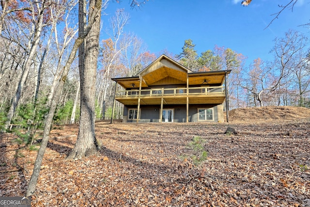 rear view of house featuring a wooden deck