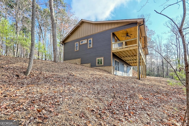 view of property exterior with ceiling fan and a deck