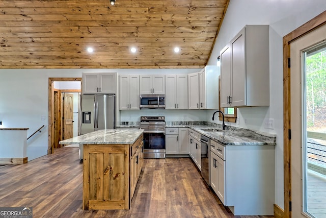 kitchen with a center island, wooden ceiling, vaulted ceiling, light stone countertops, and stainless steel appliances