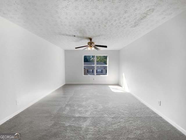 spare room with a textured ceiling, carpet floors, and ceiling fan