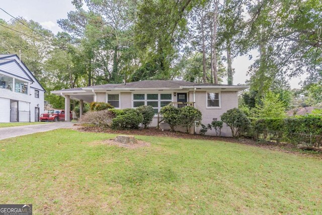 single story home with a garage, a front lawn, and a carport