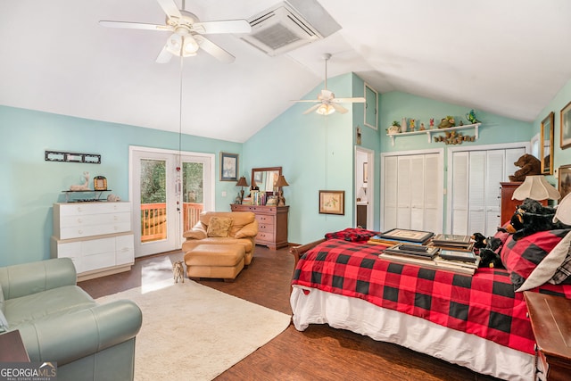 bedroom with wood-type flooring, access to exterior, ceiling fan, vaulted ceiling, and two closets