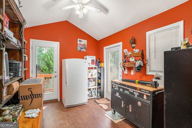 kitchen with white fridge, wood-type flooring, ceiling fan, and vaulted ceiling