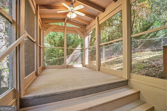 unfurnished sunroom featuring lofted ceiling with beams and ceiling fan