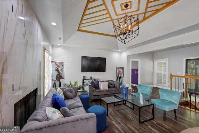 living room with a chandelier and dark wood-type flooring