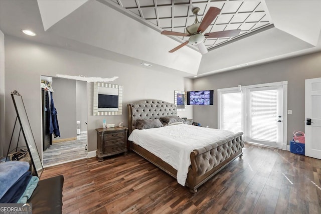 bedroom with dark wood-type flooring, a high ceiling, and ceiling fan