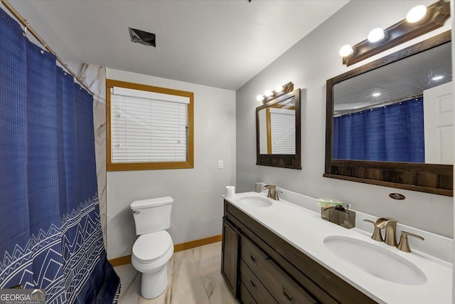 bathroom featuring vanity, toilet, and a shower with shower curtain