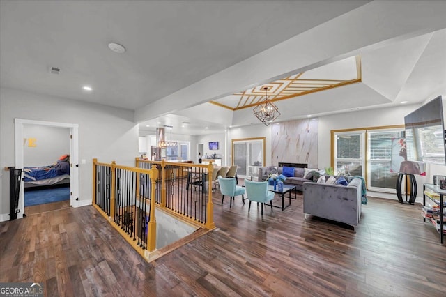 interior space with a chandelier, dark hardwood / wood-style floors, and a tray ceiling