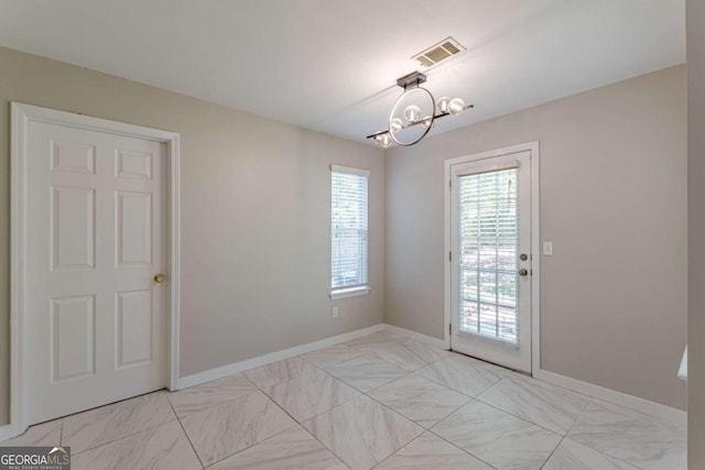 doorway with an inviting chandelier