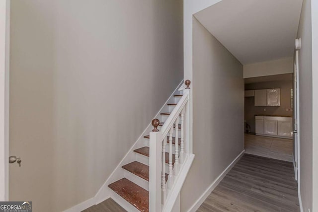 staircase featuring hardwood / wood-style flooring