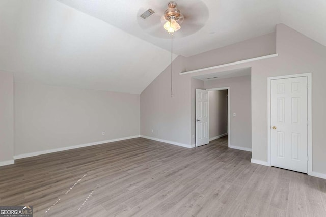 additional living space featuring ceiling fan, light hardwood / wood-style flooring, and vaulted ceiling