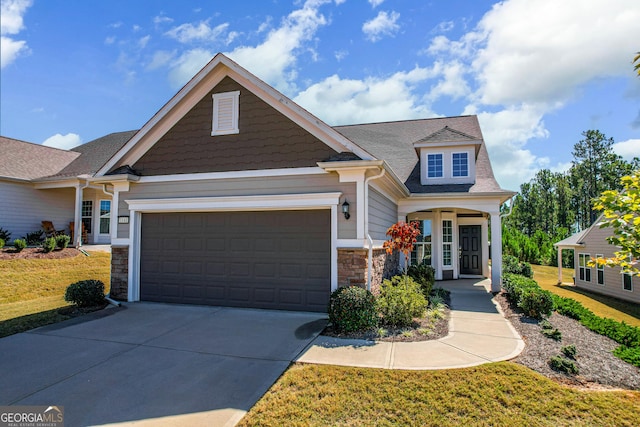 craftsman-style house featuring a garage and a front yard