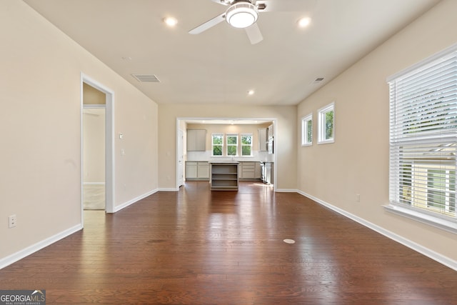 unfurnished living room with ceiling fan and dark hardwood / wood-style floors