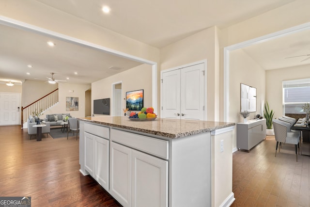 kitchen featuring a center island, white cabinets, and dark wood-type flooring