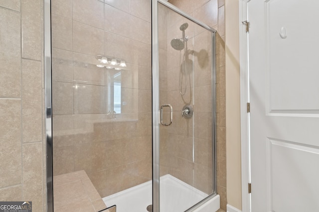 bathroom featuring a shower with door