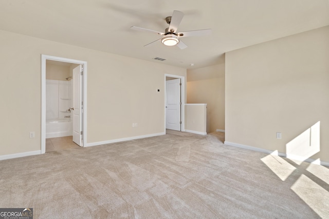 empty room with ceiling fan and light colored carpet