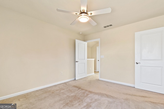 carpeted empty room with ceiling fan