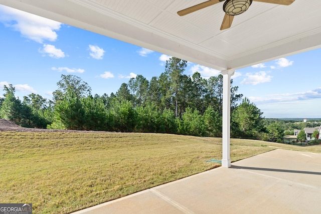 view of yard featuring ceiling fan and a patio