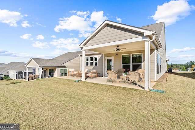 back of property featuring a lawn, ceiling fan, an outdoor living space, and a patio