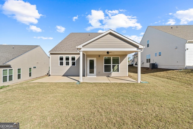 rear view of property with ceiling fan, a yard, cooling unit, and a patio