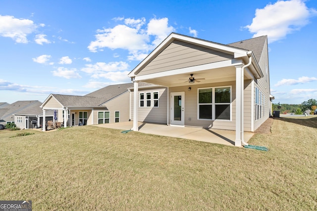 back of house with a yard, a patio, and ceiling fan