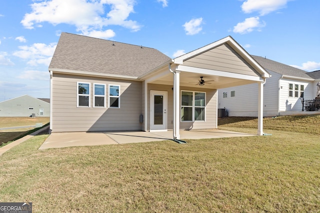 rear view of property featuring a lawn, ceiling fan, cooling unit, and a patio area