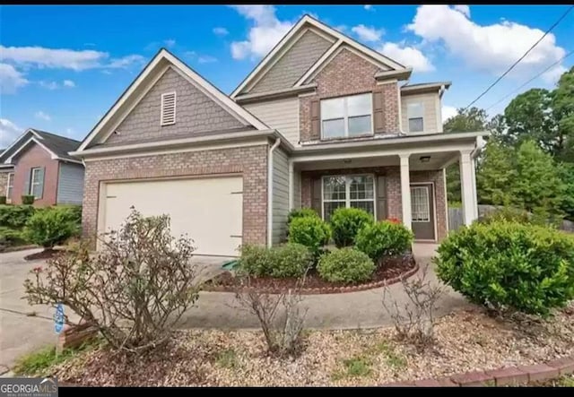 view of front of property with covered porch and a garage