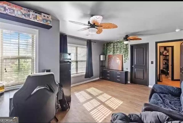 interior space with hardwood / wood-style floors, ceiling fan, and plenty of natural light