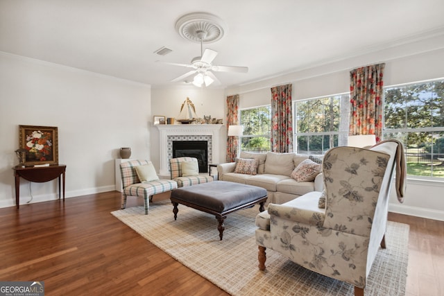 living room featuring crown molding, a wealth of natural light, and dark hardwood / wood-style flooring