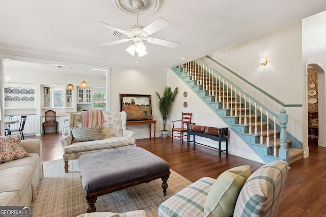 living room featuring ceiling fan and dark hardwood / wood-style floors