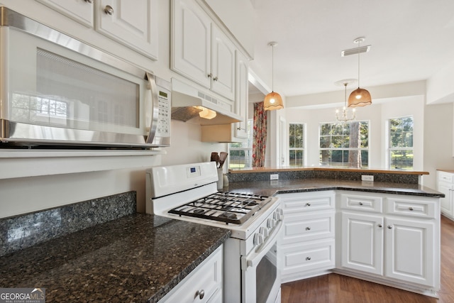 kitchen featuring white cabinetry, dark stone counters, dark hardwood / wood-style floors, pendant lighting, and white range with gas stovetop