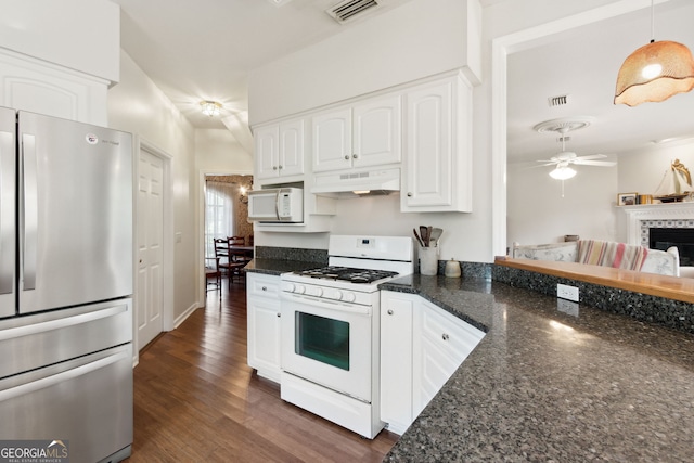 kitchen featuring white cabinets, dark hardwood / wood-style flooring, range hood, decorative light fixtures, and white appliances