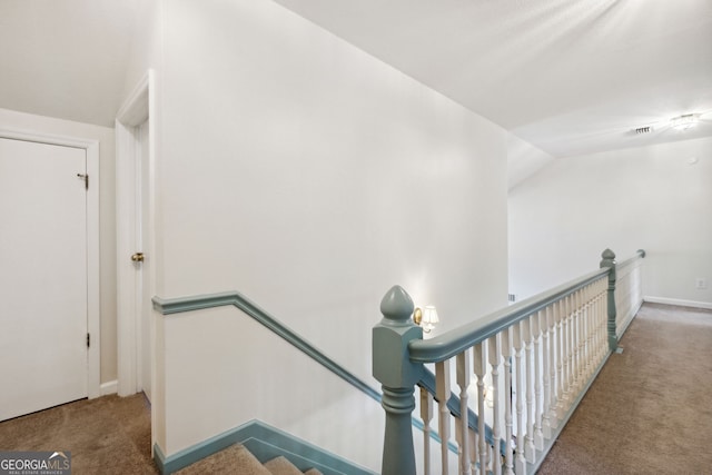 staircase with carpet floors and vaulted ceiling