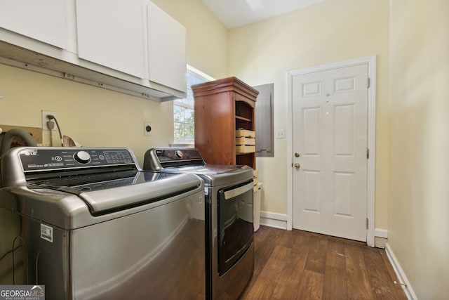 laundry room featuring dark hardwood / wood-style flooring, washer and clothes dryer, and cabinets