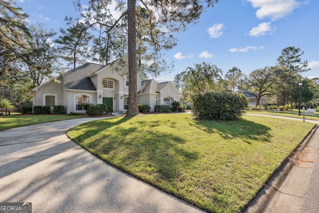 view of front of property with a front lawn and a garage