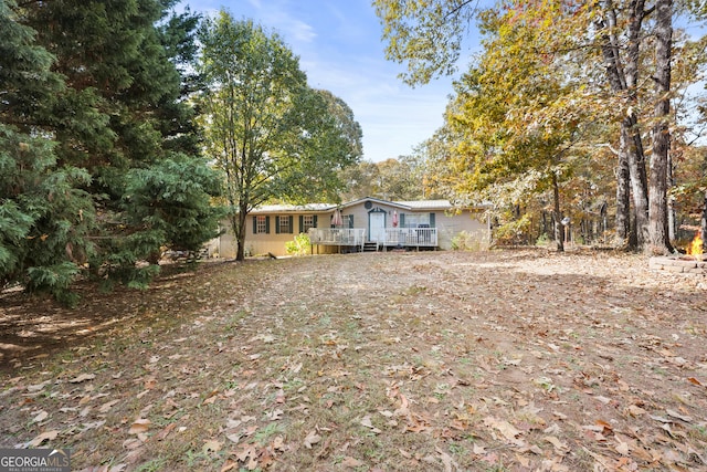 view of yard with a wooden deck