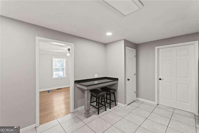 interior space with light tile patterned floors and a textured ceiling