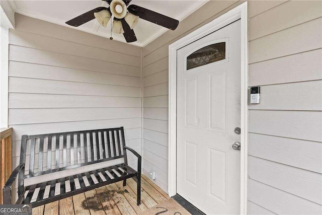 view of exterior entry featuring ceiling fan