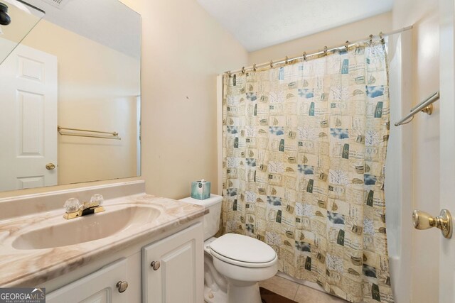 bathroom featuring walk in shower, tile patterned floors, vanity, and toilet