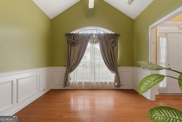 spare room with lofted ceiling and light hardwood / wood-style flooring