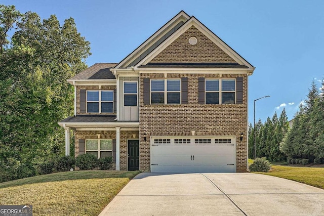 view of front of house with a front lawn and a garage