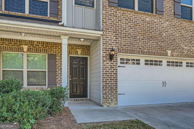 doorway to property with a garage