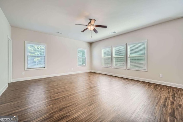 empty room featuring ceiling fan and dark hardwood / wood-style flooring