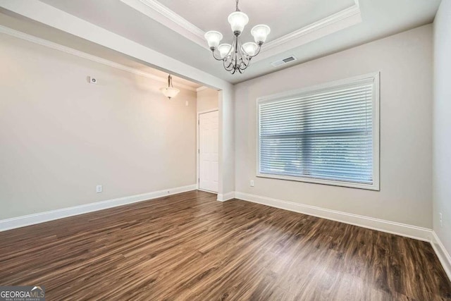 unfurnished room featuring crown molding, an inviting chandelier, a raised ceiling, and dark hardwood / wood-style flooring