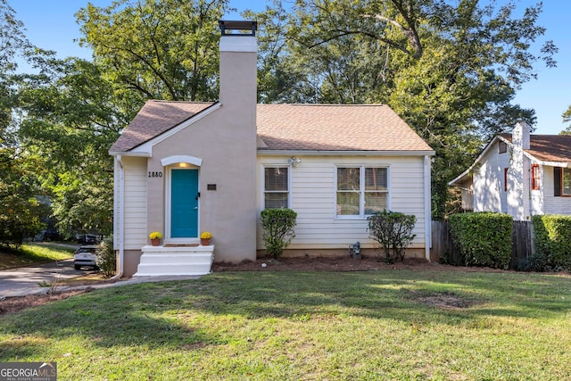 bungalow-style home with a front lawn