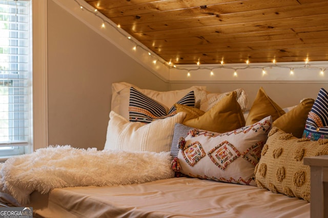 interior space with wood ceiling and track lighting