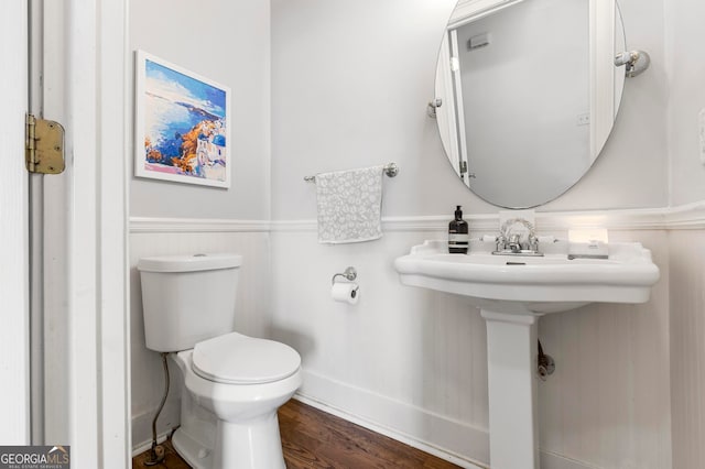 bathroom featuring toilet and wood-type flooring