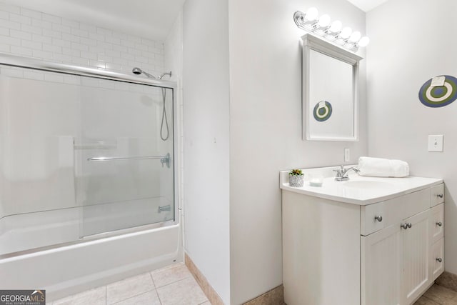 bathroom featuring vanity, combined bath / shower with glass door, and tile patterned flooring