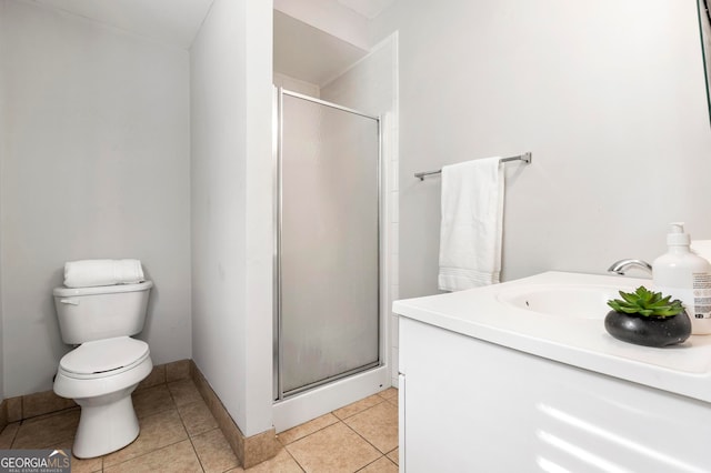 bathroom featuring a shower with door, vanity, toilet, and tile patterned flooring