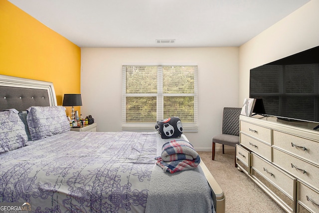 bedroom featuring light colored carpet